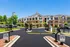 Charming gated apartment complex showcasing modern architecture, spacious balconies, and lush landscaping, ideal for a serene lifestyle.