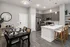 Elegant open-concept kitchen with modern appliances, sleek white countertops, and a cozy dining area.