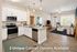 Modern open-concept kitchen and living area with chic cabinetry and elegant decor, featuring large windows for abundant natural light.
