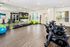 Modern fitness room with stationary bikes, vibrant fitness balls, and a mirrored wall, creating an inviting and energetic workout space.
