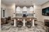 Modern communal kitchen with stylish pendant lighting, spacious island seating, and sleek cabinetry for an inviting atmosphere.