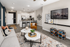 Modern open-concept living space with chic decor, cozy seating, and a sleek kitchen island with bar stools, perfect for entertaining.