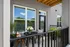 Charming apartment patio with modern brick design, featuring cozy seating, stylish decor, and vibrant greenery.