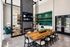 Luxurious modern lounge featuring a sleek fireplace, elegant green tile backsplash, and a spacious wooden dining table, ideal for entertainment and relaxation.