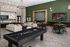 Chic and spacious entertainment lounge with pool table, stylish sofas, wall-mounted TV, and modern dining area, perfect for social gatherings.