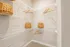 Spacious walk-in closet with sleek wire shelving and stylish wicker baskets, providing ample storage space and a clean, modern look.