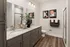 Modern bathroom with elegant dual vanity, sleek fixtures, and chic wall art, offering a luxurious and inviting ambiance.