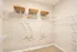 Spacious walk-in closet with sleek wire shelving and elegant wooden hangers, perfect for organizing your wardrobe.