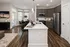Contemporary open-concept kitchen and living area featuring sleek grey cabinetry, a stylish kitchen island, and a cozy dining nook with modern seating.