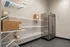Chic utility room boasting sleek metallic fridge and organized wire shelving, perfect for efficient storage.