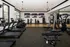 Modern fitness center with state-of-the-art treadmills, weight machines, and large TVs providing an energizing workout environment.