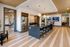 Chic contemporary kitchen with a sleek black island, modern appliances, and ambient pendant lighting, perfect for entertaining.