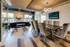 Elegant communal space with modern lighting, stylish seating, and a sophisticated conference table, perfect for meetings or relaxation.