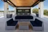 Luxurious rooftop lounge with sleek contemporary seating, twin flat screen TVs, and scenic treetop views.