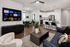 Modern open-plan living room with elegant decor, featuring a cozy seating area, contemporary kitchen with sleek appliances, and a stylish dining space.
