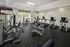 Modern fitness center with top-of-the-line exercise equipment, bright natural lighting, and an inviting atmosphere for an energizing workout.