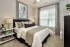 Bedroom with large window and modern finishes at Abberly Commons in Charlotte, NC.