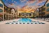 Swimming pool with in-water lounge chairs at Abberly Commons in Charlotte, NC.