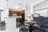 Chic open-concept kitchen and dining area with sleek granite countertops, stylish pendant lighting, and inviting seating arrangement.
