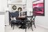 Chic and inviting dining area featuring elegant black chairs, a stylish round table, soft gray tufted bench seating, and modern decor accents.