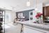 Bright and modern living space with granite countertop, stylish decor, and abundant natural light opening to a serene balcony.