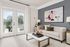 Bright and elegant living room with modern art, cozy sofa, stylish decor, and double glass doors opening to a scenic view.