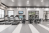 Modern fitness center equipped with state-of-the-art treadmills and ellipticals, bright and inviting with stylish overhead lighting.