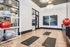 Modern fitness room featuring yoga mats and exercise balls on sleek wooden floors, ideal for workouts or meditation.