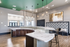 Stunning modern kitchen with elegant marble countertops, chic pendant lighting, and contemporary wood cabinetry perfect for stylish gatherings.