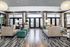 Luxurious and modern lobby area featuring chic decor, elegant seating, and large windows for natural light.