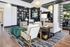 Luxurious living room with modern decor, featuring elegant furniture, eye-catching light fixtures, and a spacious open layout.