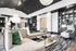Elegant, modern living room with plush sofas, chic chandeliers, and stylish shelving, perfect for relaxation and entertaining.