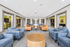 Inviting communal lounge with plush seating in modern blue and tan tones, accented by natural light and contemporary decor.