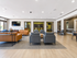 Bright and spacious communal lounge with modern seating, flat-screen TV, and stylish decor, perfect for social gatherings or relaxation.
