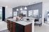 Modern apartment interior featuring a sleek kitchen with granite countertops, open living area with stylish decor, and cozy dining space.