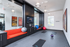 Contemporary fitness room with sleek design, vibrant decor, gym mats, and exercise balls offering an inviting space for home workouts.