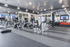 Modern gym with state-of-the-art exercise equipment, sleek design, and ample natural light, perfect for fitness enthusiasts.