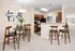 Bright and airy open-plan kitchen and dining area with modern wood furniture and elegant decor accents.