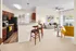 Elegant open-concept apartment with a sleek kitchen, cozy living room, and stylish decor, featuring bright windows and modern furnishings.