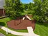 Charming outdoor playground surrounded by lush greenery, featuring swings and a slide for family fun.