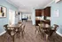 Inviting communal space with modern table seating, a sleek kitchenette, and a billiards table for entertainment.