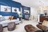 Modern living room with sleek blue accent wall, stylish furniture, and elegant decor creating a cozy ambiance.