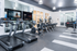 Modern fitness center with state-of-the-art treadmills, elliptical machines, and strength training equipment, complemented by a sleek design and bright ambiance.