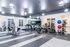 Modern fitness center with state-of-the-art equipment, treadmill stations, gym balls, and ample natural lighting.