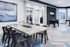 Modern game room and lounge with decorative art, elegant marble table, and foosball setup, offering a stylish and inviting space.