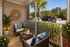 Charming screened porch with cozy wicker chairs and lush greenery, perfect for relaxing in style.
