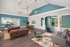 Elegant and spacious living area featuring modern furniture, high ceilings, and stylish lighting, complemented by a chic kitchen and inviting dining space.