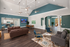 Elegant open-concept living space featuring stylish furniture, high ceilings, and modern lighting, seamlessly connecting to a chic kitchen and inviting dining area.