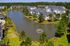 Charming lakeside apartment community with modern architecture, scenic views, and lush greenery.