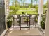 Charming patio oasis with cozy seating, vibrant plants, and scenic green views, perfect for relaxation and enjoying the outdoors.